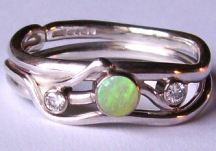 sinuous ring design now set with an opal and two diamonds
