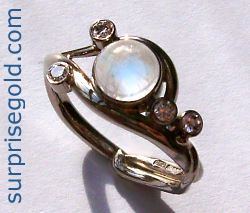 6mm moonstone and four smaller diamonds