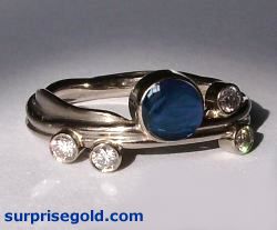 5mm cabochon sapphire and four diamonds in white gold