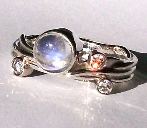 moonstone engagement ring with three diamonds