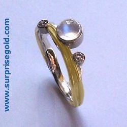 one 5mm moonstone and two smaller diamonds with white and yellow gold