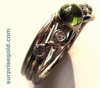 sinuous green tourmaline ring with green and white diamonds